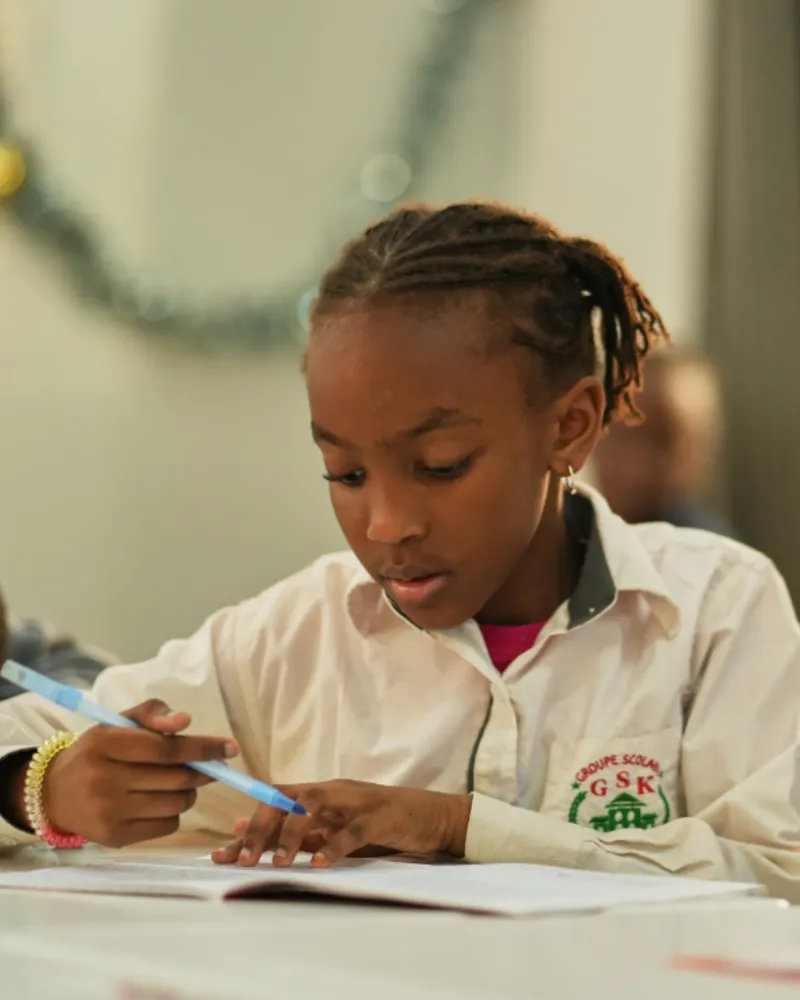 Groupe Scolaire Kambal student in class, focused on schoolwork