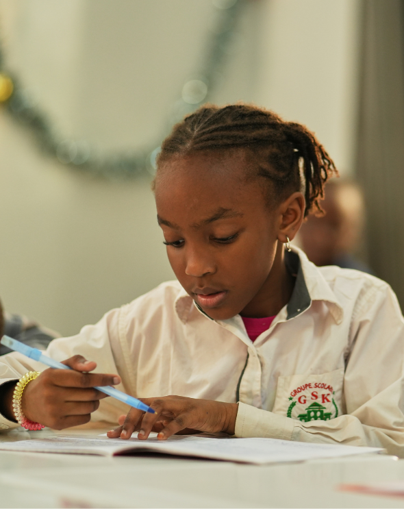 Groupe Scolaire Kambal student in class, focused on schoolwork
